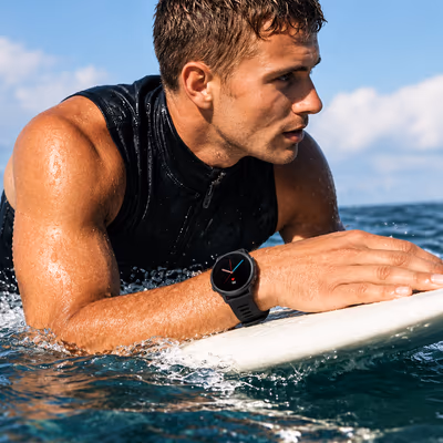 A surfer lying on his board, wearing a Veyra